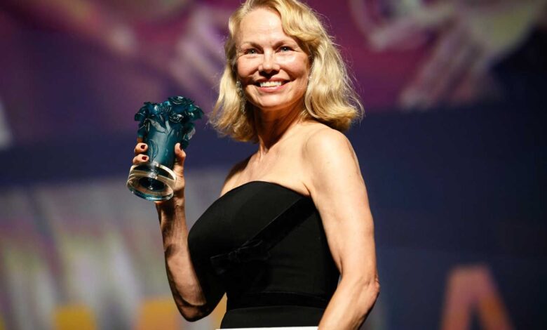 US actress Pamela Anderson poses holding her trophy after being awarded a Deauville Talent Award prize