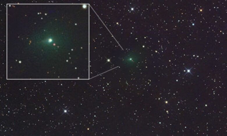 A glowing green light is seen in the center of a starry image from space but also in a white cutout box on the left part of the image